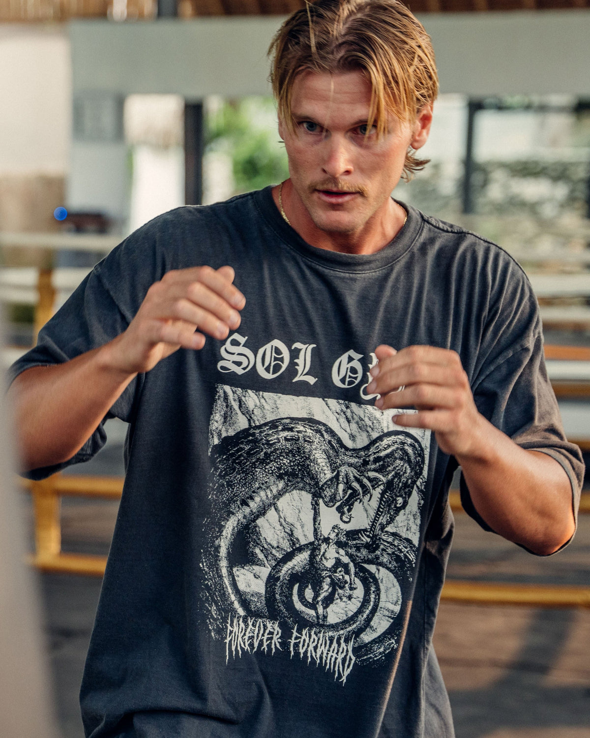 Man in a fighting stance wearing the faded black Vintage Dragonslayer Pumpcover