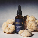 Aurum Lion's Mane Extract bottle with dried lion's mane mushrooms on a neutral background
