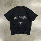 Black SOL GYM t-shirt with white text on a textured gray surface