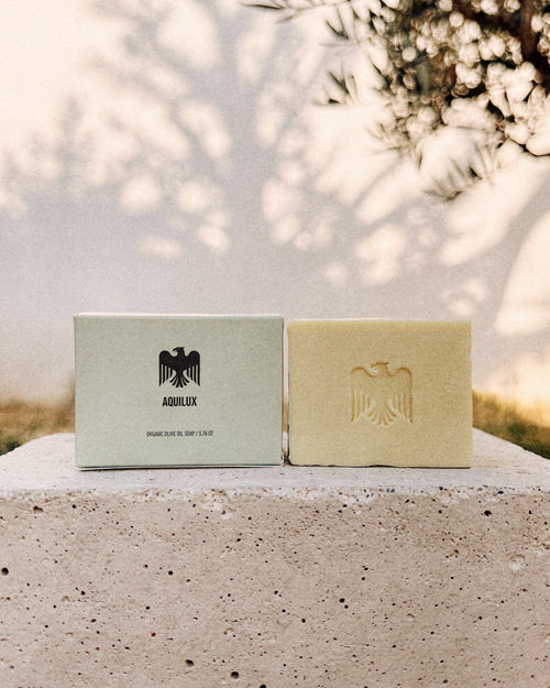 Aquilux Organic Olive Oil Sol Soap bar on a natural surface