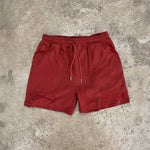 lifeguard red shorts on concrete floor