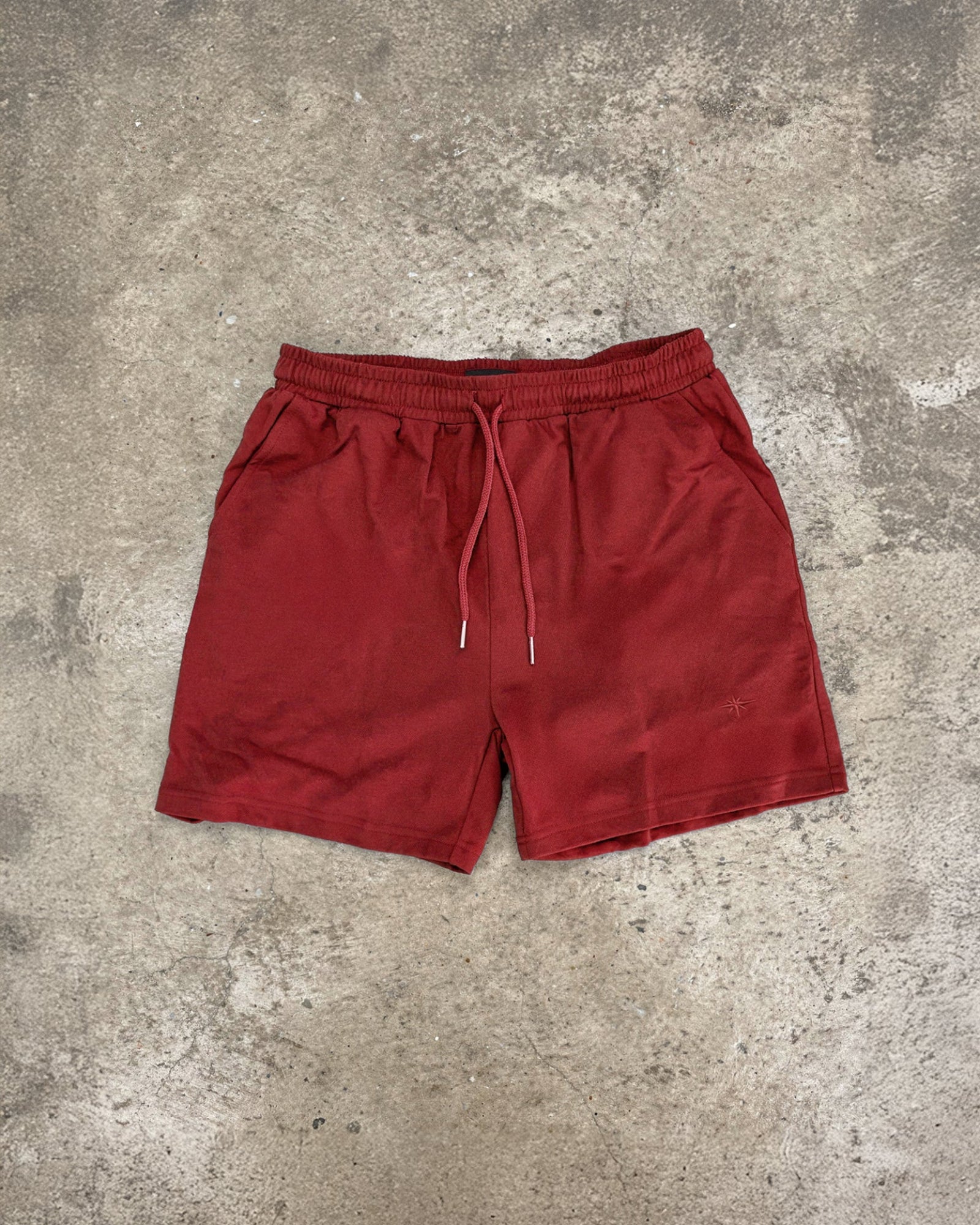 lifeguard red shorts on concrete floor