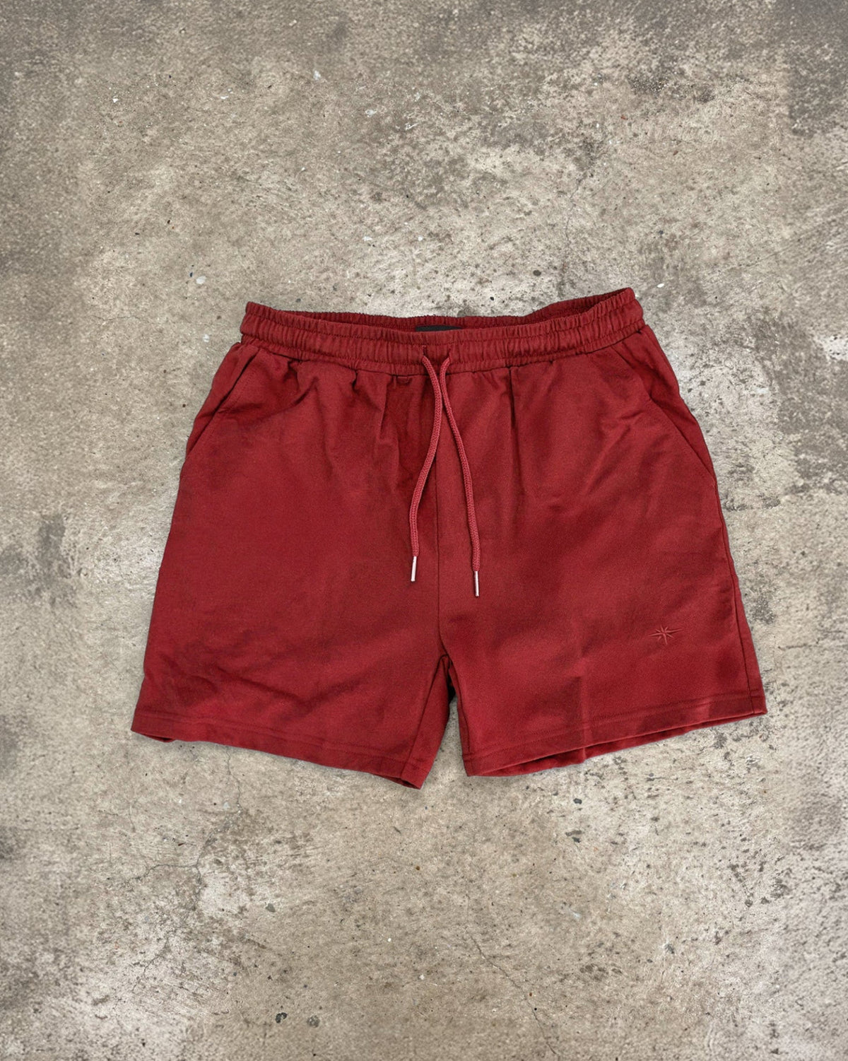 lifeguard red shorts on concrete floor