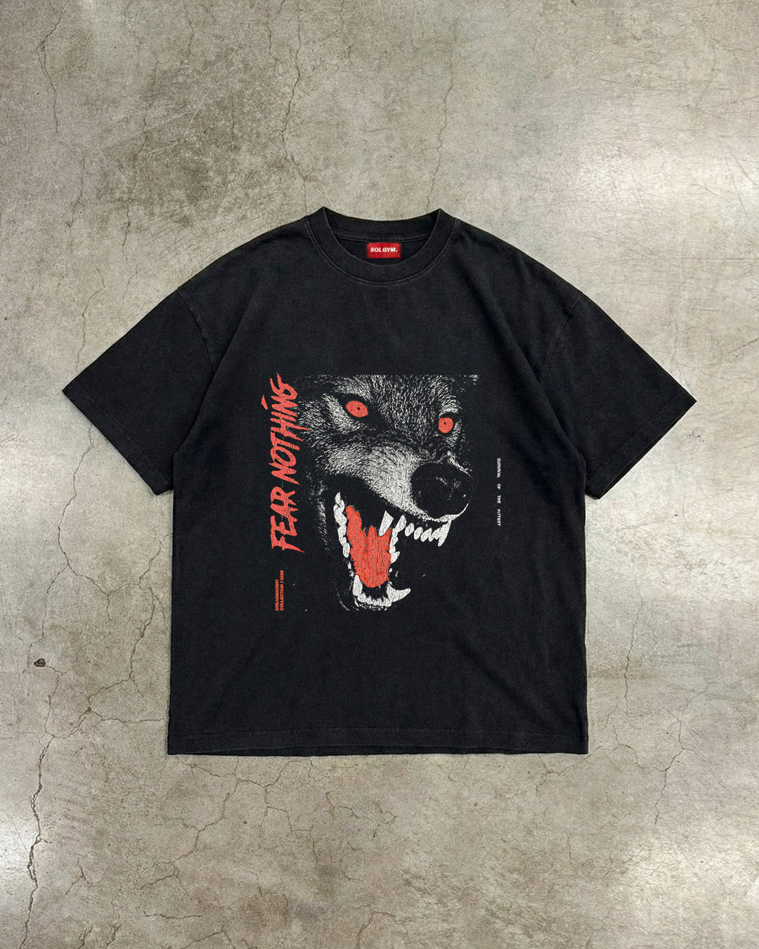 Black t-shirt with a wolf graphic and 'FEAR NOTHING' text on a textured surface